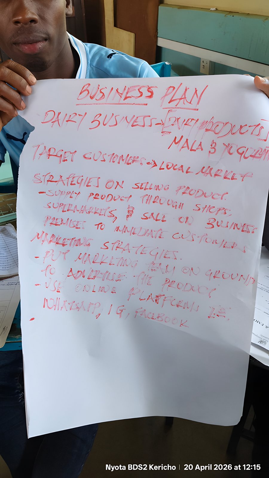 A participant presenting a dairy business plan on a flip chart